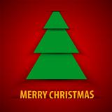 Green paper Christmas tree on red background