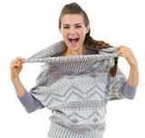 Happy woman playing with sweater collar