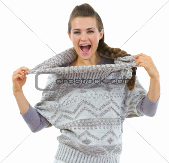 Happy woman playing with sweater collar