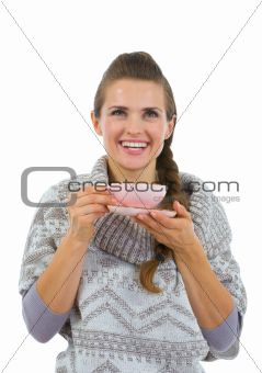 Happy woman in sweater having hot beverage