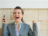 Happy business woman rejoicing success