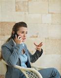 Concerned business woman speaking mobile phone