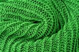 close up green knitted pullover background