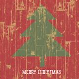 Christmas tree symbol and greetings on wooden planks texture. Ve