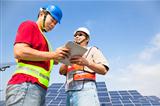  two workers  discussing with tablet pc before  solar power stat
