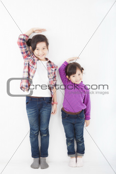 two beautiful asian little girls standing together