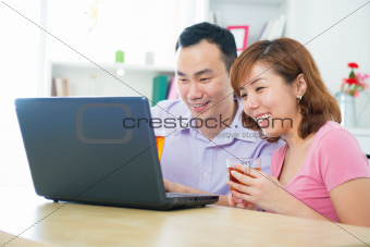 Asian couple using notebook