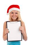 Young woman in santa hat holding blank board