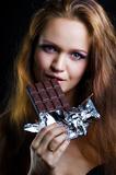 sexy young woman eating chocolate