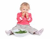 small girl eating grean peas