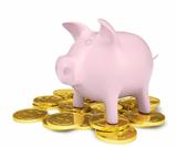 Pink piggy bank standing on a pile of coins with gold