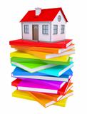 A small house on a stack of colorful books