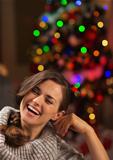 Portrait of smiling young woman in front of Christmas lights