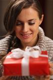 Happy young woman holding Christmas present box
