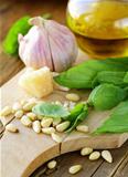 ingredients for pesto, basil, olive oil, pine nuts, garlic and parmesan