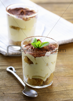 Traditional Italian dessert tiramisu in a glass beaker