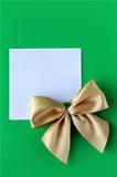 white blank with a gold bow on a green background