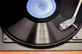 Vintage record player with spinning vinyl. Motion blur image. 