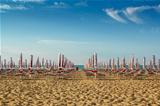 withdrawn umbrellas and sunlongers on the sandy beach