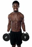 Attractive man posing with dumbbells