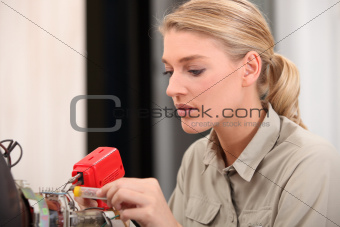 female technician working on an electronic circuit