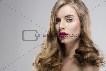 girl with flowing hair portrait looks in to the lens