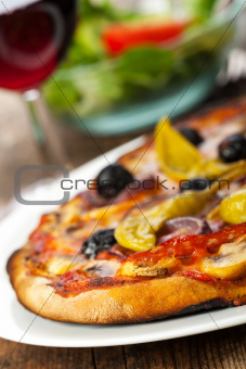 closeup of a pizza with red wine 