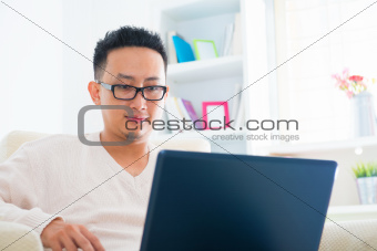 Asian male using notebook