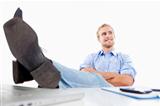 relaxed young man at office with his feet on the desk