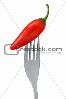 chili pepper on a fork on white