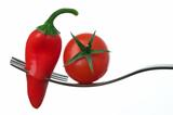 chili pepper and tomato on a fork