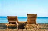 Two wooden beach chair, sea and clean sky