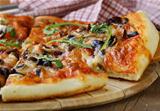 Italian pizza with mushrooms and olives on a wooden board