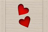 Two red hearts in a wooden board