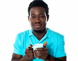 African guy holding coffee mug