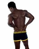 Back pose of young fit male trainer