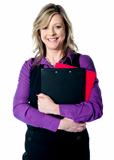 Corporate woman holding documents tightly