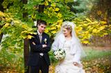 bride and groom  in autumn