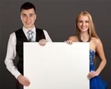 Young man and woman with blank board
