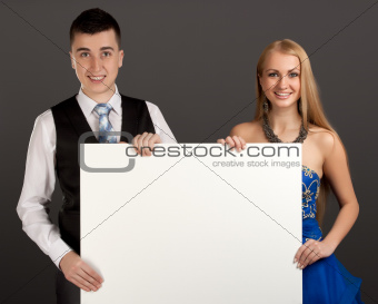Young man and woman with blank board