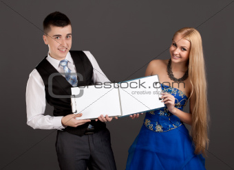 Young man and woman holding clip boards