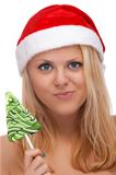 Young blond woman in santa hat with candy