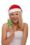 Young blond woman in santa hat with candy