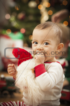 Cute Infant Mixed Race Baby Enjoying Christmas Morning Near The Tree.