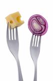 red onion and cheese on forks against white