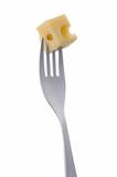 cheese cube on a fork against white
