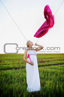 young pregnant woman in a white greek dress