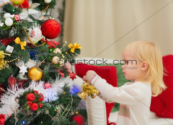 Baby decorating Christmas tree