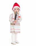 Baby girl in Christmas hat using microphone