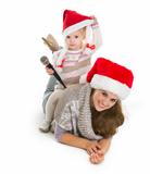 Baby girl in Christmas hat with microphone sitting on mother back
